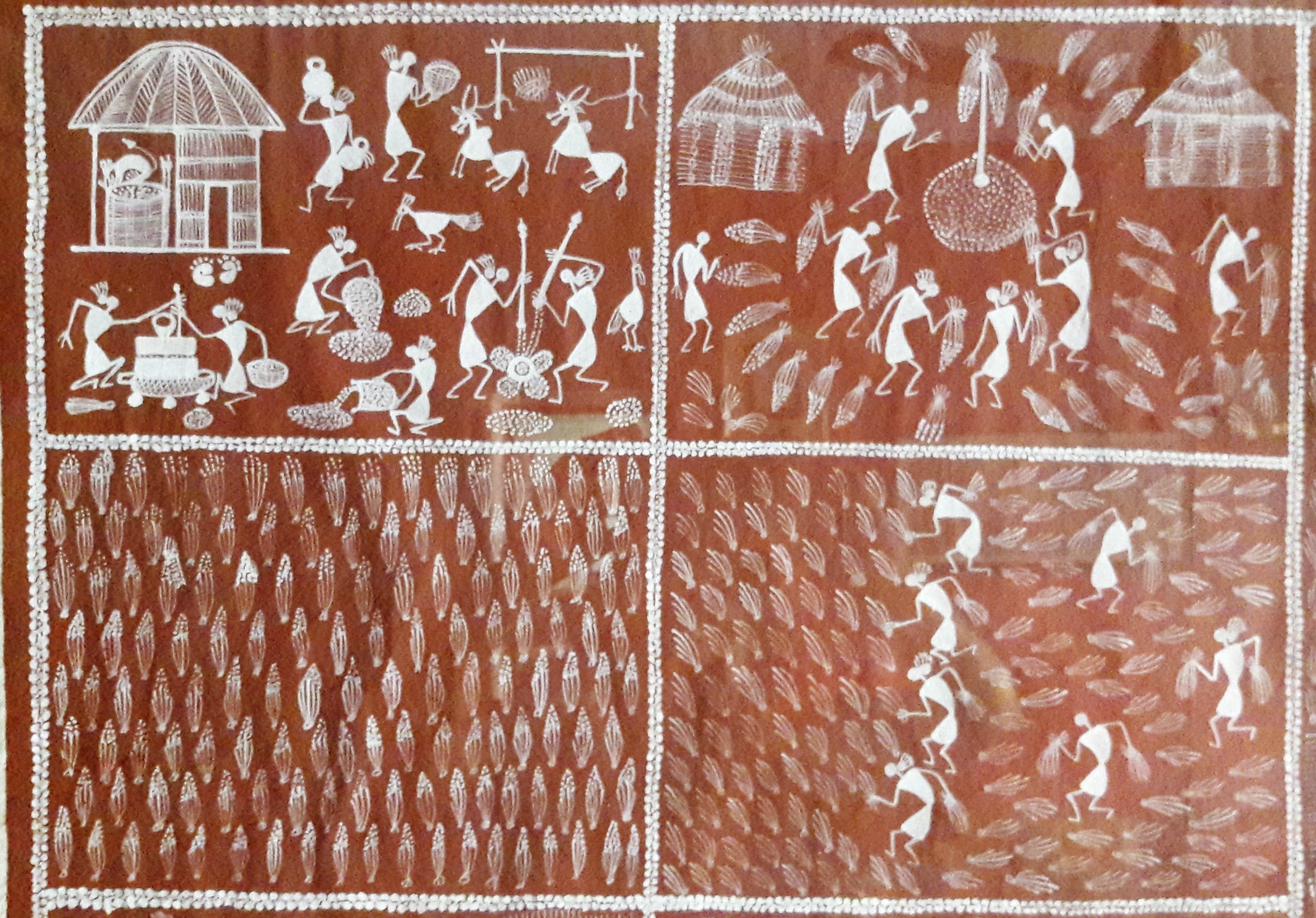 Warli mural showing village life, dance, animals, sun, and procession